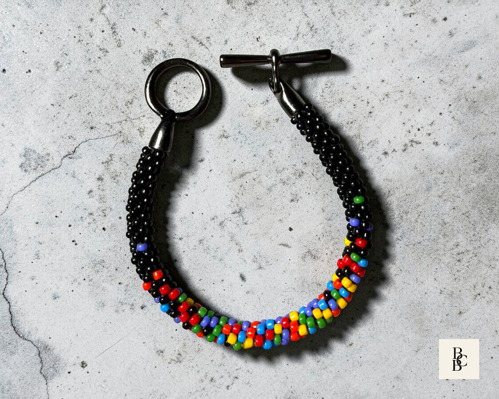 Confetti Explosion Pride Kumihimo bracelet with multicolor glass seed beads, detailed angled view