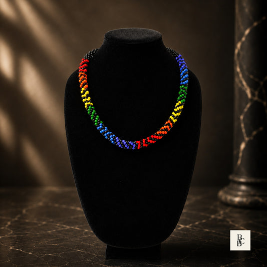 Rainbow Illusion Pride Kumihimo necklace front view on black velvet bust, handmade rainbow beaded jewelry with black accents