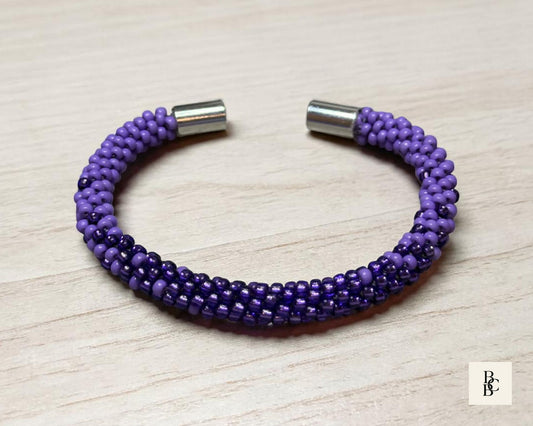 Open Shades of Violet Alzheimer’s Awareness Kumihimo bracelet showing purple glass seed beadwork and the silver-tone magnetic clasp ends.