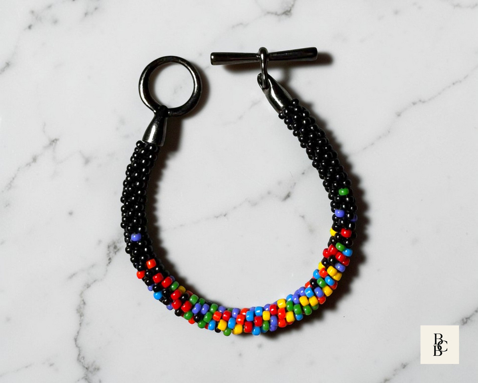 Full view of Confetti Explosion One Spectrum Pride Kumihimo bracelet with multicolor glass seed beads