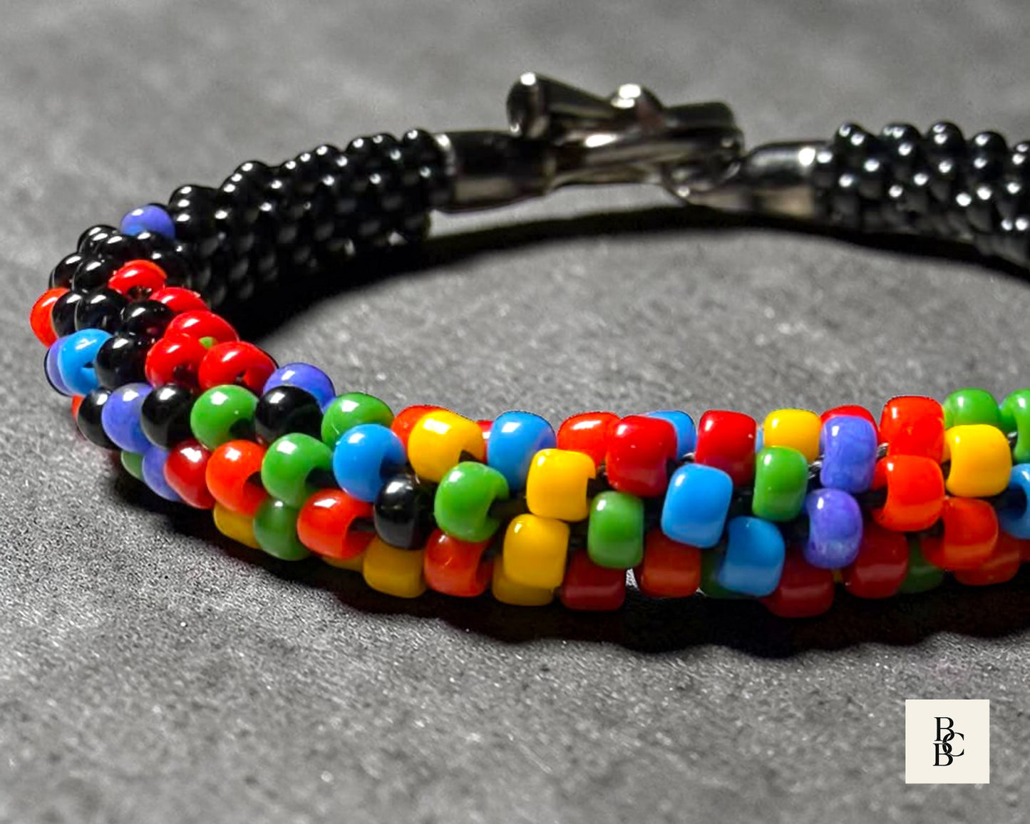Texture close-up of Confetti Explosion One Spectrum Pride Kumihimo bracelet showing multicolor glass seed bead weave